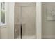 Modern walk-in shower with glass door and tiled walls, offering a clean and spacious bathing experience at 1552 Bright Coral Trl, Wendell, NC 27591