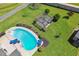 Aerial view of a backyard with a pool, pergola, and lush lawn, creating an ideal outdoor oasis at 17 Kaki Ct, Selma, NC 27576