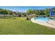 Expansive backyard with a pool, pergola, lush green grass, and mature trees, ideal for outdoor activities at 17 Kaki Ct, Selma, NC 27576
