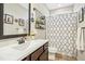 Charming bathroom with patterned shower curtain, vanity, and decorative shelving at 17 Kaki Ct, Selma, NC 27576