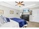 Comfortable bedroom with dark wood dresser, wall mounted TV, and calming decor at 17 Kaki Ct, Selma, NC 27576