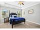 Cozy bedroom featuring a dark wood four-poster bed, neutral walls and natural light at 17 Kaki Ct, Selma, NC 27576