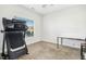 Functional bedroom space featuring a treadmill and desk near the window at 17 Kaki Ct, Selma, NC 27576