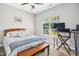 Comfortable bedroom featuring a light wood bed frame, soft decor, and natural lighting at 17 Kaki Ct, Selma, NC 27576