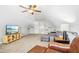 Large bonus room featuring a sectional sofa, TV, and bright lighting at 17 Kaki Ct, Selma, NC 27576