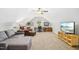 Spacious bonus room with a comfy sectional sofa, workspace, and media center at 17 Kaki Ct, Selma, NC 27576