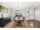 Elegant dining area with tray ceilings, wood floors, and a chandelier fixture at 17 Kaki Ct, Selma, NC 27576