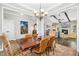Open dining area features tray ceilings, a chandelier and view into the living area at 17 Kaki Ct, Selma, NC 27576