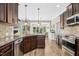 Bright kitchen with stainless appliances, granite counters and wood look flooring at 17 Kaki Ct, Selma, NC 27576