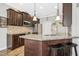 Kitchen with dark wood cabinetry, granite countertops, stainless appliances and wood floors at 17 Kaki Ct, Selma, NC 27576