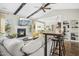 Bright living room with fireplace, vaulted ceilings, ceiling fan, and bar seating at 17 Kaki Ct, Selma, NC 27576
