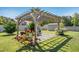 Backyard pergola with mature landscaping provides a shady spot for outdoor enjoyment at 17 Kaki Ct, Selma, NC 27576