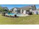 Backyard pool with an outdoor eating area and pristine lawn at 17 Kaki Ct, Selma, NC 27576
