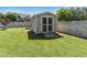 Backyard storage shed with ramp for easy access at 17 Kaki Ct, Selma, NC 27576