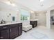 Bathroom with dual vanities, decorative rug and seat, and a glass enclosed shower at 1701 Bodwin Ln, Apex, NC 27502
