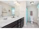 Bathroom featuring a double sink vanity, tile floor, and bright lighting, creating a fresh and functional space at 1701 Bodwin Ln, Apex, NC 27502