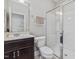 Bathroom with a glass enclosed shower, dark wood vanity, and bright, neutral tones at 1701 Bodwin Ln, Apex, NC 27502