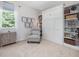 Bedroom with Murphy bed, built-in shelving, and a comfortable reading nook, bathed in natural light at 1701 Bodwin Ln, Apex, NC 27502