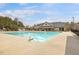 Large community swimming pool with multiple lanes, lounge chairs, and a nearby clubhouse for residents at 1701 Bodwin Ln, Apex, NC 27502