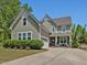 Charming two-story home featuring a well-manicured lawn, inviting front porch and a spacious driveway at 1701 Bodwin Ln, Apex, NC 27502