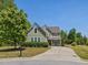 Charming two-story home with a well-manicured lawn, mature trees and inviting driveway at 1701 Bodwin Ln, Apex, NC 27502