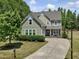 Beautiful exterior showcasing the house's architectural design, landscaping, and driveway with basketball hoop at 1701 Bodwin Ln, Apex, NC 27502