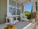 Relaxing front porch featuring Adirondack chairs, side table, and decorative flower accents at 1701 Bodwin Ln, Apex, NC 27502
