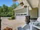 View of a two car garage with adjacent seating on a decorative front porch at 1701 Bodwin Ln, Apex, NC 27502