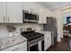 Modern kitchen with stainless steel appliances and granite countertops at 1701 Bodwin Ln, Apex, NC 27502