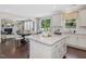 Open kitchen layout with island, granite countertops, and white cabinetry at 1701 Bodwin Ln, Apex, NC 27502