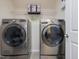 Well-equipped laundry room featuring modern front-load washer and dryer, offering convenience and efficiency for laundry care at 1701 Bodwin Ln, Apex, NC 27502
