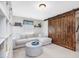 Living room featuring comfortable seating, large wooden barn door, and built-in shelving at 1701 Bodwin Ln, Apex, NC 27502