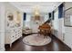 Cozy living room with a grand piano, area rug, and bright natural light at 1701 Bodwin Ln, Apex, NC 27502