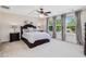 Main bedroom with tray ceiling, ceiling fan, and three windows with curtains and blinds at 1701 Bodwin Ln, Apex, NC 27502