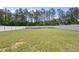 Large backyard with a white fence and lush lawn, offering plenty of space for recreation and relaxation at 178 Ashpole Trl, Clayton, NC 27520