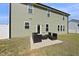 Green home exterior showcasing a concrete patio with outdoor seating, ideal for enjoying the backyard at 178 Ashpole Trl, Clayton, NC 27520
