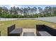 Spacious backyard with a white fence, lush lawn, and modern patio seating, perfect for outdoor entertaining at 178 Ashpole Trl, Clayton, NC 27520