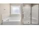 Bathroom featuring a large tub and glass door shower at 178 Ashpole Trl, Clayton, NC 27520