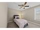 Neutral bedroom featuring a ceiling fan, a window, and comfortable furnishings, perfect for relaxation at 178 Ashpole Trl, Clayton, NC 27520