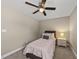 Neutral bedroom featuring a ceiling fan, a window, and comfortable furnishings, and a bedside table at 178 Ashpole Trl, Clayton, NC 27520