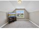 Bedroom with a window and TV on a stand, offering a cozy space for relaxation at 178 Ashpole Trl, Clayton, NC 27520