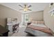 Bright bedroom featuring a ceiling fan, a vanity table and a decorative pink-themed Parisian aesthetic at 178 Ashpole Trl, Clayton, NC 27520