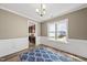 The dining area features wainscoting, a modern light fixture, and a blue accent rug at 178 Ashpole Trl, Clayton, NC 27520