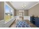 Elegant dining room enhanced by wainscoting, large window, and hardwood flooring at 178 Ashpole Trl, Clayton, NC 27520
