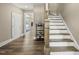 Inviting entryway with hardwood floors, staircase, and stylish decor at 178 Ashpole Trl, Clayton, NC 27520