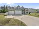 Home's exterior features a spacious driveway, well-manicured lawn, and inviting curb appeal at 178 Ashpole Trl, Clayton, NC 27520