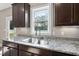 Close up of kitchen sink with window and granite countertops at 178 Ashpole Trl, Clayton, NC 27520
