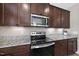 Stainless steel microwave and oven atop granite countertops at 178 Ashpole Trl, Clayton, NC 27520