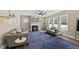 Living room with fireplace, two sofas, a large ceiling fan, and lots of windows at 178 Ashpole Trl, Clayton, NC 27520