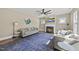 Bright living room with sofas, fireplace, and a large ceiling fan at 178 Ashpole Trl, Clayton, NC 27520